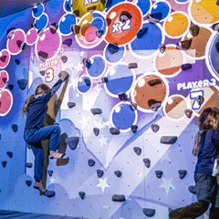 Augmented Climbing Wall with girl playing Whack-a-Bat exergame