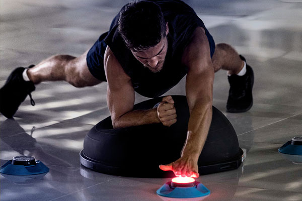 Young male fitness training with BlazePod touch sensors