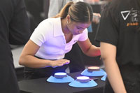 Young woman at expo with BlazePod wireless touch sensors